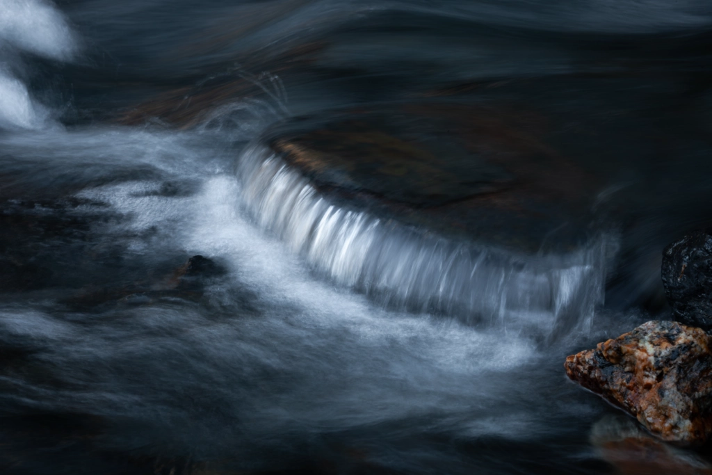 Rivière des Pyrénées prise en pose longue pour révéler les ondulations filantes de l'eau, photographie d'art de Jill Pollock, Vaea Designs
